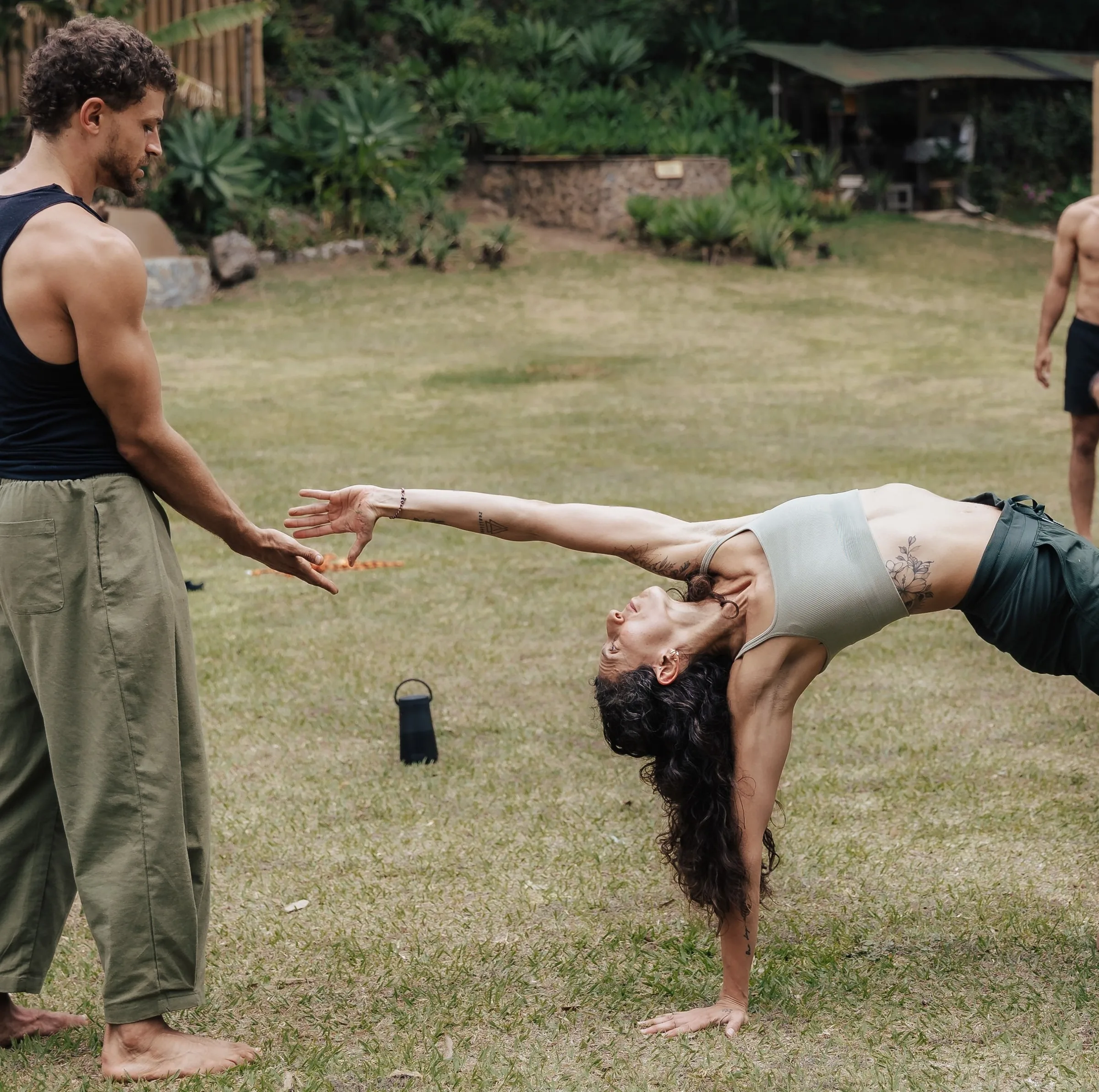 Omar Thali guiding a client through an assisted backbend during a 1:1 coaching session