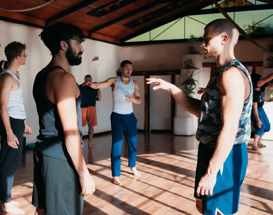 A group movement class in session, instructor demonstrating a cue
